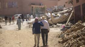 People walk through the wreckage caused by the earthquake, in the town of Amizmiz, near Marrakech, Morocco. An aftershock rattled Moroccans on Sunday as they mourned victims of the nation’s strongest earthquake in more than a century and sought to rescue survivors while soldiers and aid workers raced to reach ruined mountain villages. (Mosa'ab Elshamy/AP)