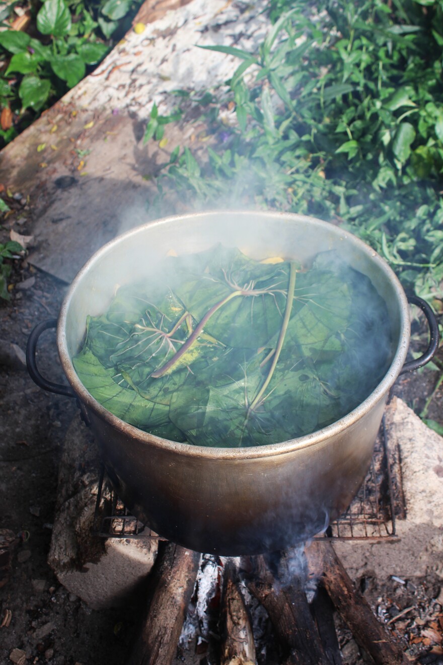 This steaming pot of oil down, with callaloo leaves on top, is ready to eat.