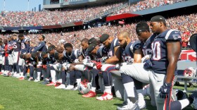 Members of the New England Patriots — and players across the league — kneel during the national anthem before Sunday's game against the Houston Texans.