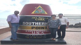 Cuban Ambassador to the U.S. JosÃ© RamÃ³n CabaÃ±as, far right, visits the Southernmost Point in Key West Tuesday.