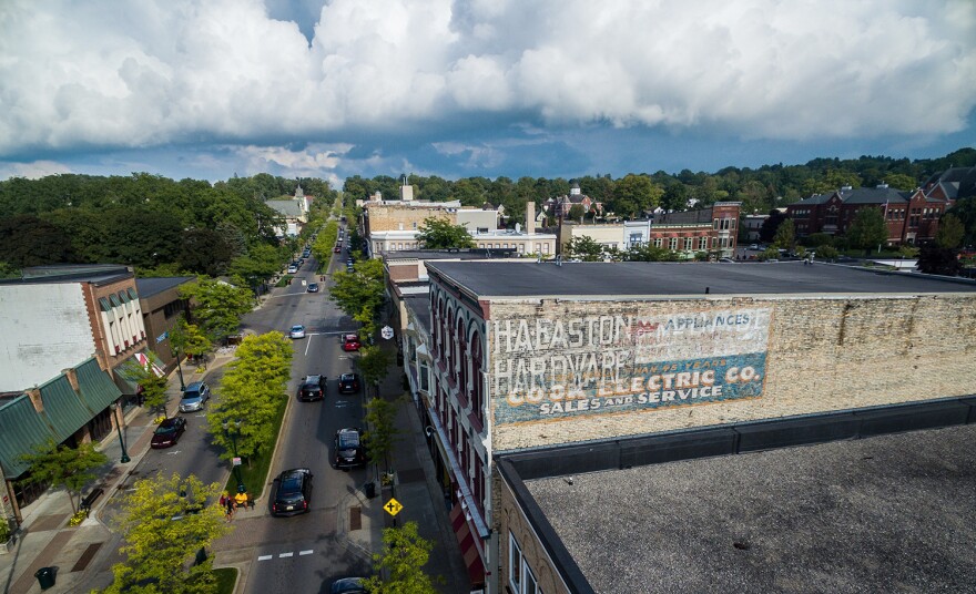 An old mural on the Coburn building in downtown Petoskey was recently repainted by artist Äbby Kent.