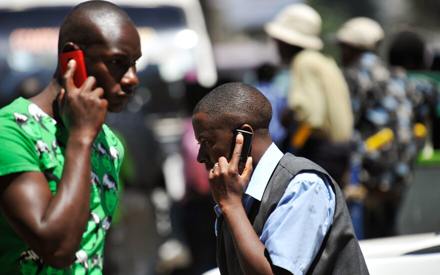 Cellphones are everywhere in the developing world, as this Nairobi street scene shows. Bill and Melinda Gates believe the phones can be used for everything from farmer education to instant banking.