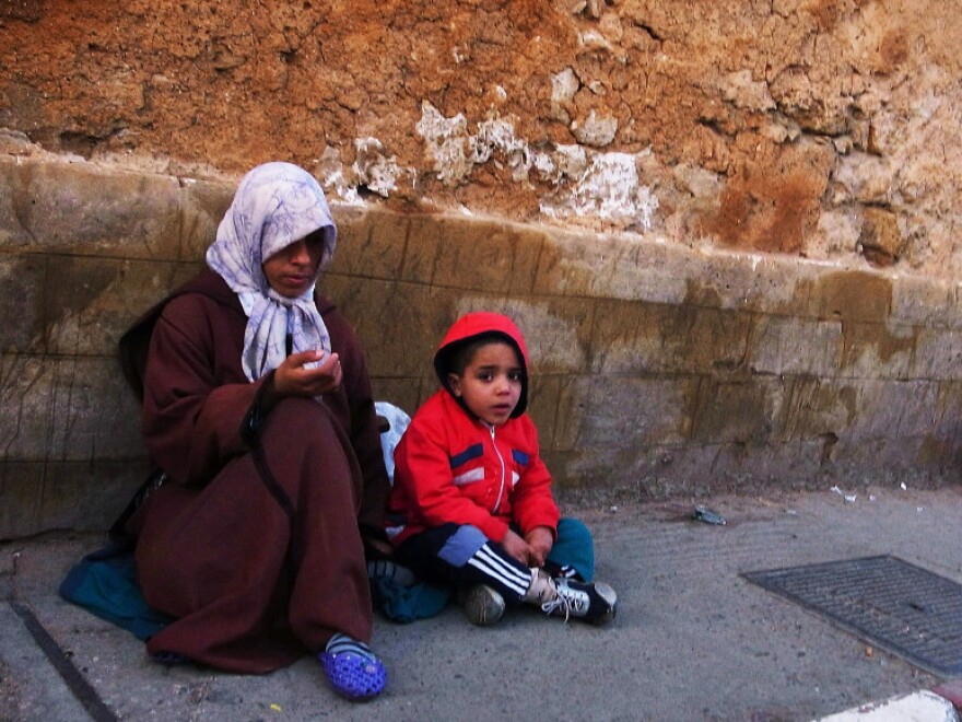 A Moroccan mother and child beg for money in Rabat, Morocco, last year. About 15 percent of the population lives on $2 a day, and the literacy rate is little more than 50 percent.