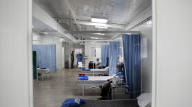 An elderly man recovers from a respiratory illness in a special section built for COVID-19 patients. (Jorge Saenz/AP)