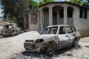 FILE - Vehicles that were set on fire by armed gangs sit in the Cite Soleil neighborhood of Port-au-Prince, Haiti, May 12, 2026.