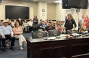 Janet Garrison from Mason County spills letters of support from people across the country who support their efforts to stop data center development in their rural community.