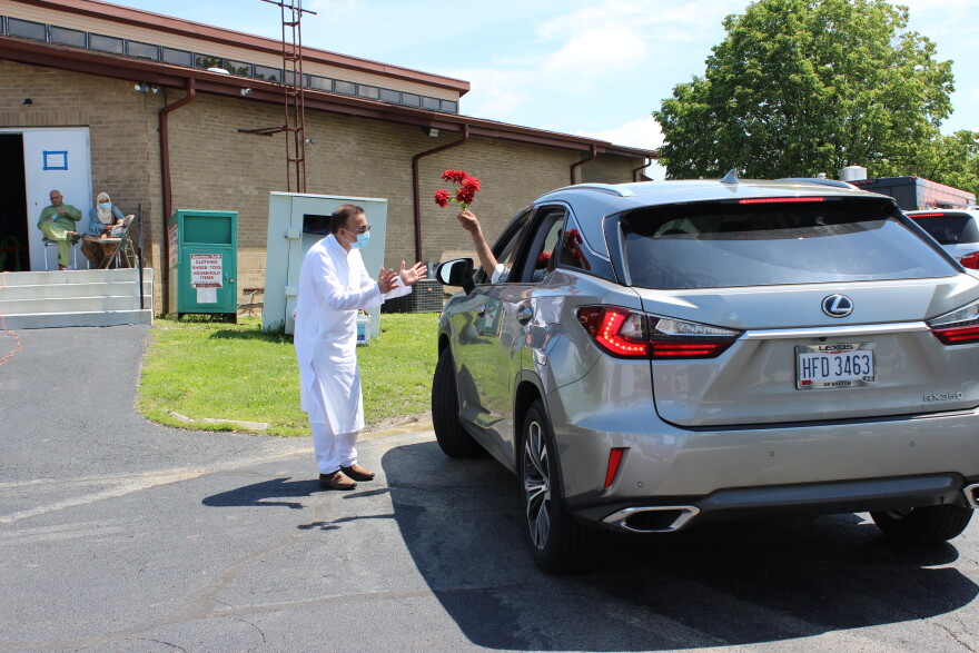 Cars decorated with flowers, streamers, and homemade banners drove through the parking lot at the Dayton Mercy Society's mosque in Miamisburg.