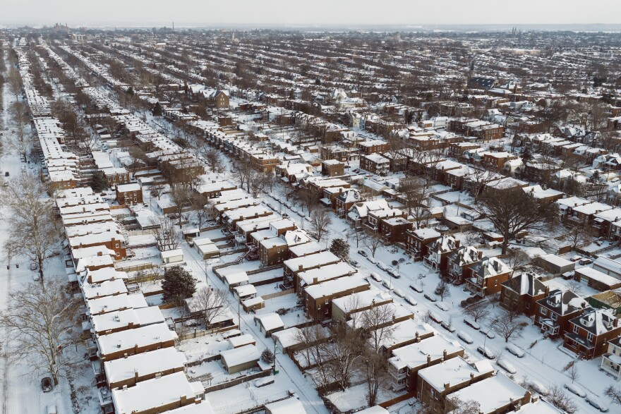 Homes in St. Louis’ Tower Grove South neighborhood are blanketed by snow on Sunday, Jan. 25, 2026, in south St. Louis.