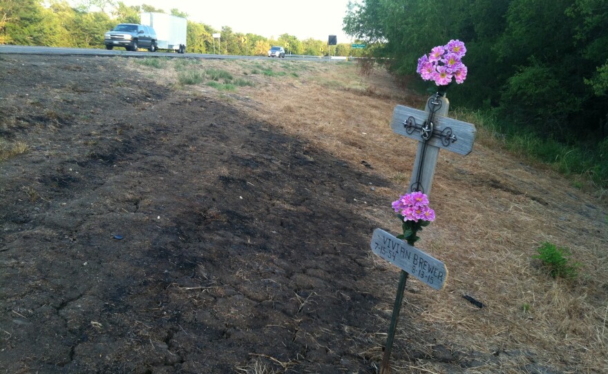 A cross marks the spot of a head-on collision that killed two people on State Highway 19 east of Cooper on Aug. 13.