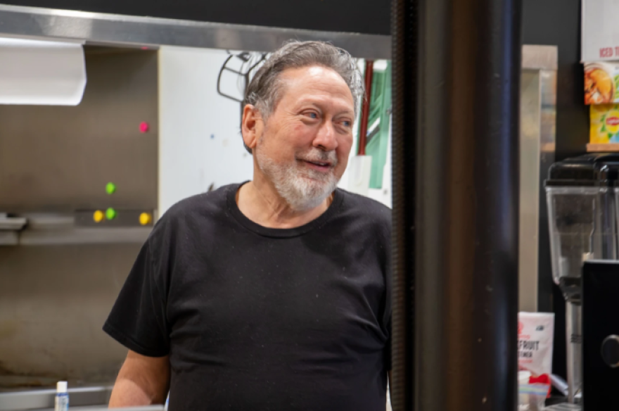 Dale Trujillo talks to a customer at No Cow Bakery and Cafe in Edmond. His restaurant has options for people with alpha-gal syndrome and other allergies.