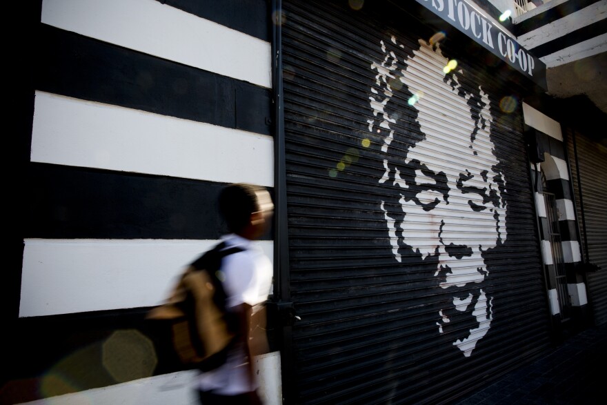 A man walks past a mural of Mandela in Woodstock, a Cape Town suburb. Mandela's portrait is no stranger to the walls of Cape Town.