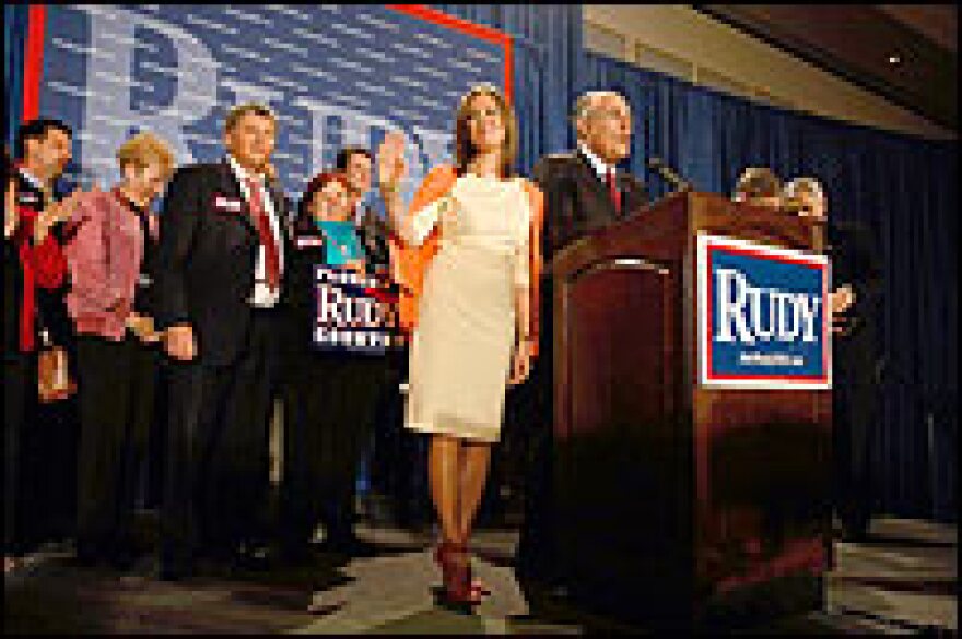 Former New York City Mayor Rudolph Giuliani speaks as his wife, Judith, looks on during a post-primary campaign rally in Orlando, Fla., on Tuesday.