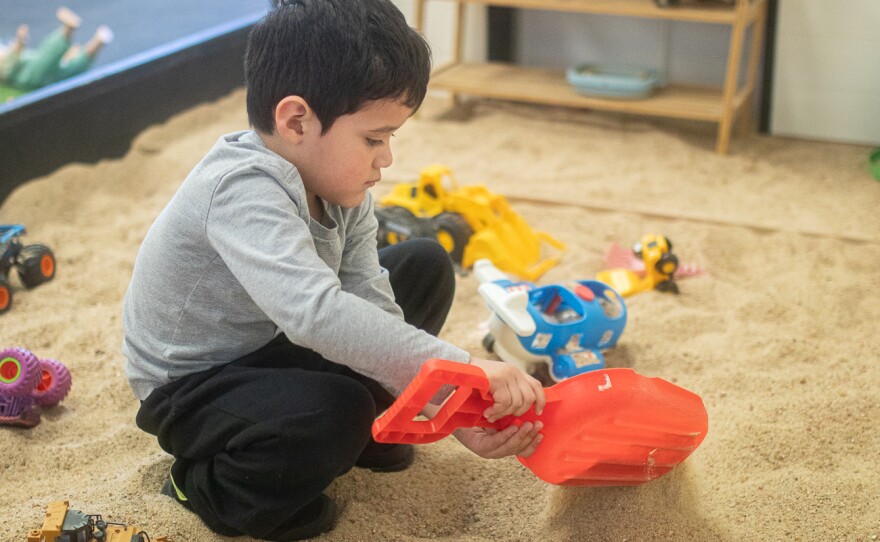 Jacob Núñez digs a while in the sand-box at Play & Party Co. The building is located at 8981 West Central Avenue in Wichita.