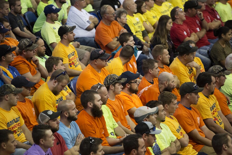 Members of labor unions watch speakers at a rally last year in St. Charles.