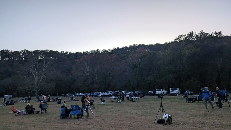 Festivalgoers set out chairs and blankets as night approaches at the 2024 DarkSky Missouri Festival near Van Buren, Missouri.
