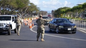 National Guard personnel direct traffic away from the wildfire-damaged areas in Lahaina, Hawaiʻi, Sunday, Aug. 13, 2023, following wildfire that caused heavy damage. (AP Photo/Rick Bowmer)
