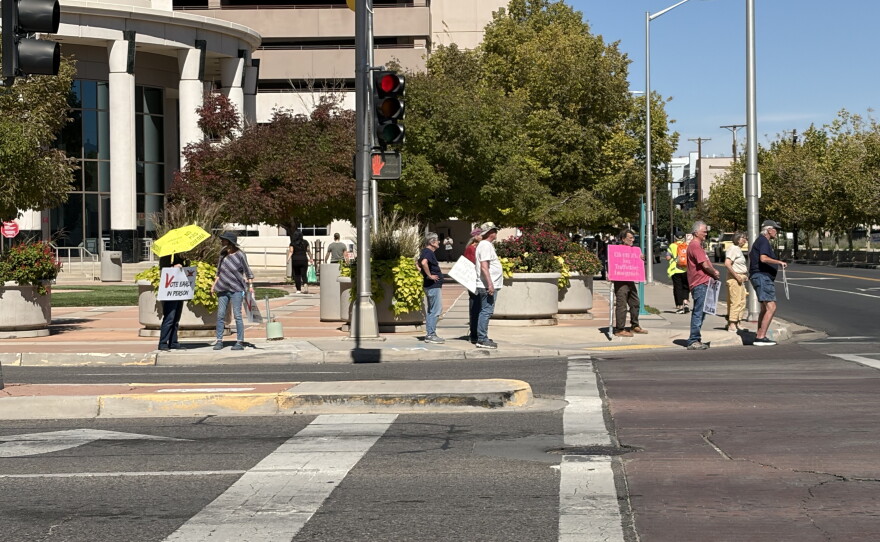 Members of Indivisible ABQ held signs encouraging motorists to vote early on Lomas Ave on Wednesday October 7, 2026.
