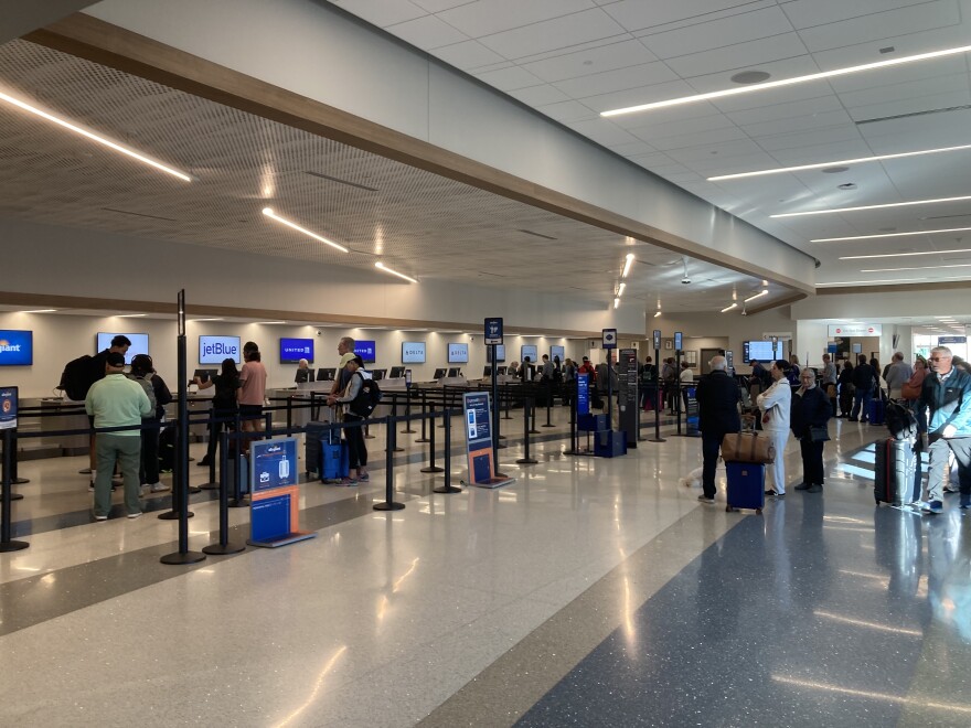 Passengers line up inside the ticketing area in Asheville Regional Airport's North Concourse Friday, October 17, 2025.