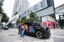a woman is seen walking out of a Freebee car in front of Brickell City Centre