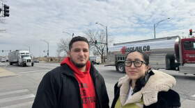 José Miguel Acosta Córdova and Paulina Vaca stand at the intersection of Pulaski Road and 41st Street in Chicago's Archer Heights neighborhood. A recent study found that over 24 hours, more than 5,000 trucks and buses pass through this spot. (Juanpablo Ramirez-Franco/WBEZ)