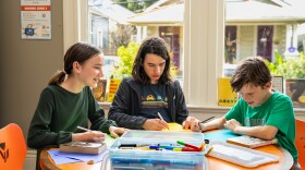 Siblings, Ada, 12, Paul, 14, and Jack, 10, attend a middle school book club at the Cita Dennis Hubbell Library on July 30, 2026.