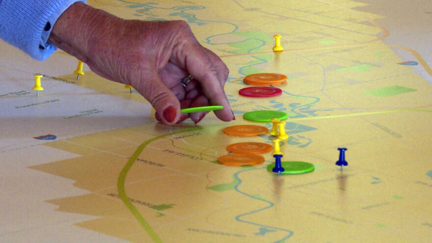 Residents near Carmel placed chips along a map of the river to show what places they think should be preserved (green), enhanced (orange), left alone (blue), or if the designers should develop an new destination (red).