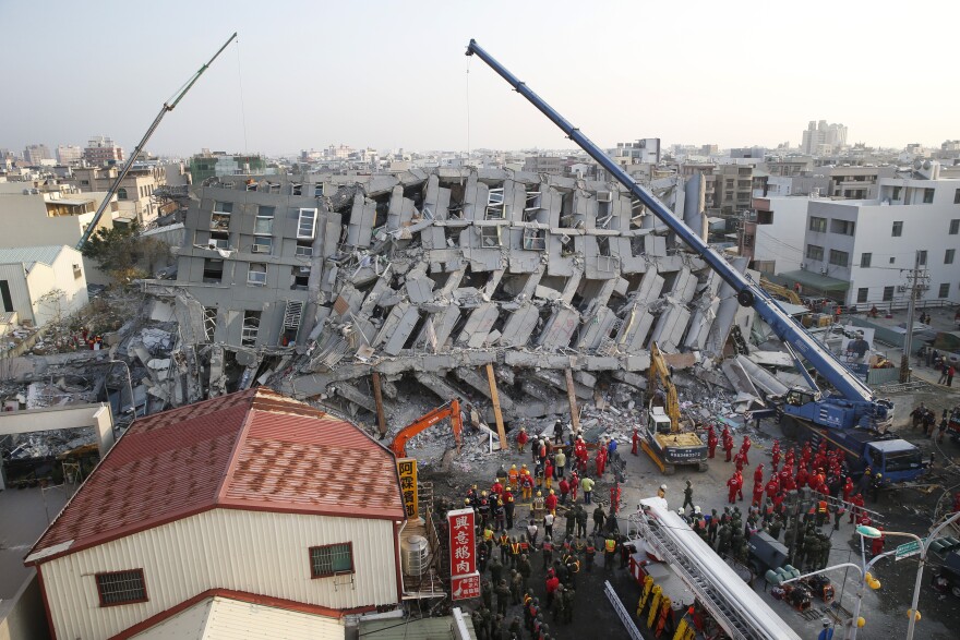 In the early morning, emergency rescuers continue to search for the missing in a collapsed building from Tainan, Taiwan, on Sunday.