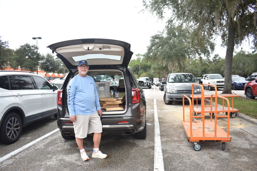 Chris Ansley, of Wesley Chapel, loads plywood into the trunk of his SUV. He said it's the first time in 25 years that he has boarded up his windows ahead of a hurricane.