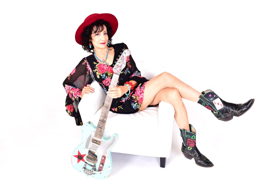 Rosie Flores sits with her instrument of choice, the electric guitar