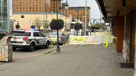 Police barricades and evidence markers outside The Gaslight Lounge following a fatal shooting on Sunday, July 20, 2025.