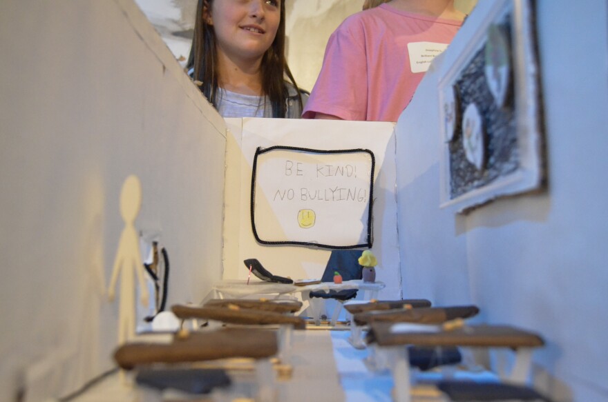 The "Brilliant Bookworms" team from English Landing Elementary School split their exhibit into two scenes to show the classroom and cafeteria depicted in the book “The Smallest Girl in the Smallest Grade.”