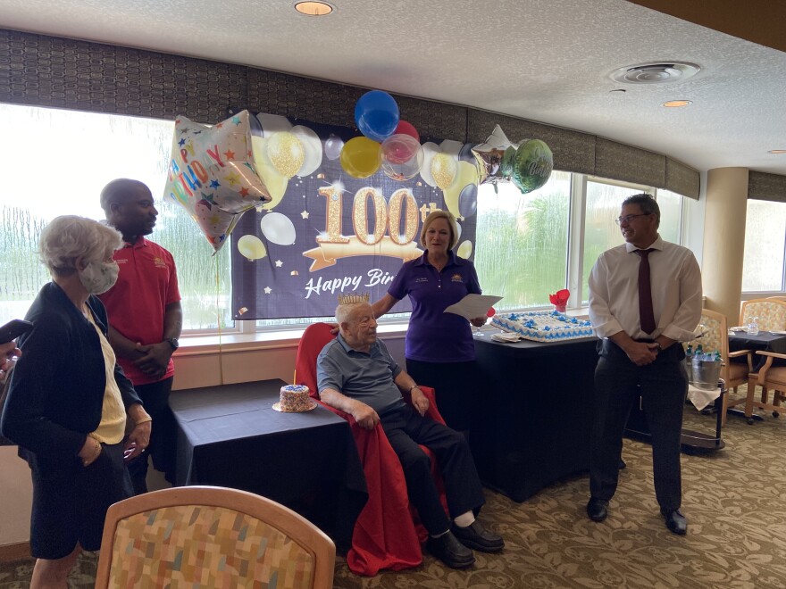 Abe Friedman, center, is surrounded by (from left) his daughter Lois, Vice Mayor Joshua Simmons, Commissioner Joy Carter, center right, and Coral Springs Mayor Scott Brook as a Happy Birthday sits behind them on a window.