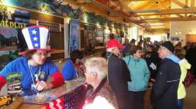 Cruise visitors wait in line at the Ketchikan Visitors’ Bureau building to buy shore excursions. (Photo by Leila Kheiry/KRBD)