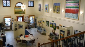 Paintings, pottery and mixed media artwork are displayed on the high walls and main floor of the Red Door Art Gallery in Wahpeton, ND.