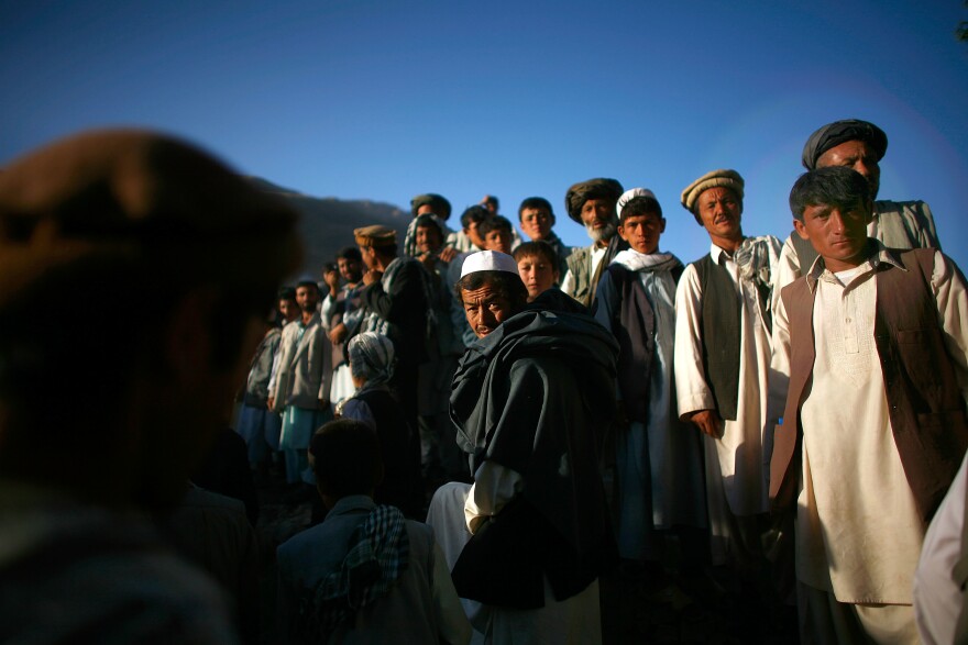 Afghan men assemble for a campaign visit from President Hamid Karzai.