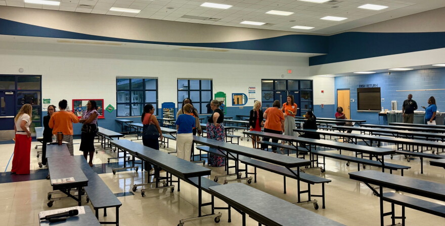 Community members talk in the Oakcrest Elementary cafeteria after a meeting about the proposed Wyomina Park rezoning. Many of those in attendance were Oakcrest staff members and parents with their children.