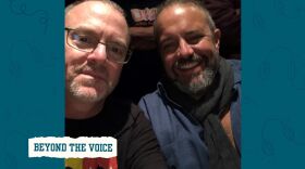 Two men smiling