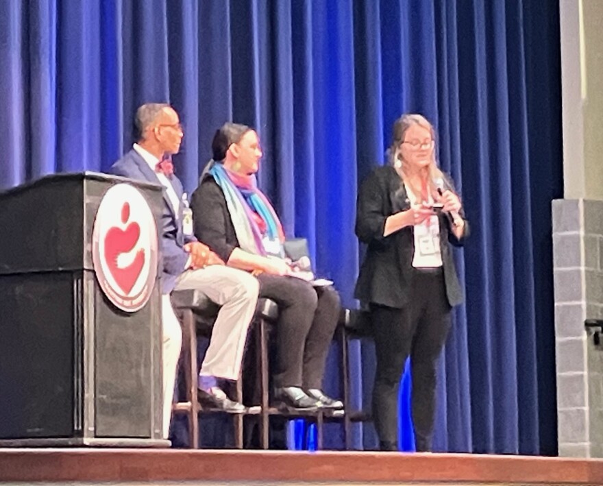 Annika O'Melia (right), creator and host of Rock Island Line, speaks at the poverty conference Thursday, April 9 at Waterfront Convention Center, Bettendorf.