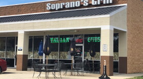 A man shot and wounded by a Raleigh Police officer on Tuesday, was seen by a 911 caller outside Soprano's Grill, allegedly flashing a gun.