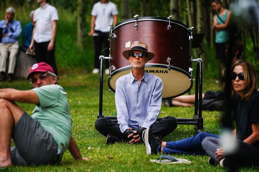 Composer John Luther Adams sits in an open field in Aspen during a performance of “Crossing Open Ground,” a piece he composed for the Aspen Music Festival and School and the Barry Lopez Foundation for Art and Environment. Adams has spent the last decade and a half creating “outdoor music” intended to be performed and experienced in the open air.