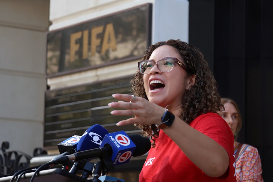Yareliz Mendez-Zamora, Policy Coordinator with American Friends Service Committee, speaks outside of FIFA's Miami office in Coral Gables Oct. 2, 2025.