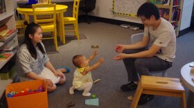 Every Tuesday afternoon, Qingming Huang (right) and Tao Lin would bring their daughter to the Samuel P. Harn Museum of Art to play with her. “It is a quiet place to stay with our daughter, and it would be easy for us to take care of her here,” Lin said. (Zhiming Zhang/WUFT News)