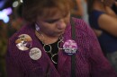 A woman wears a pair of buttons she saved from the 1989 Mobilize for Women's Lives Rally