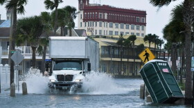 A truck plows through St. Augustine's flooded historic district on Wednesday.