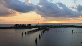 The sun sets behind the lock and dam on Lake Okeechobee and St. Lucie Canal.