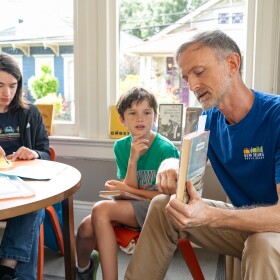 Simon Hand, a children’s librarian, shares his book pick — Jacob Have I Loved by Katherine Paterson — with the middle school book club he runs on July 30, 2026.