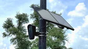 Flock Safety surveillance camera on a lightpole on High Street
