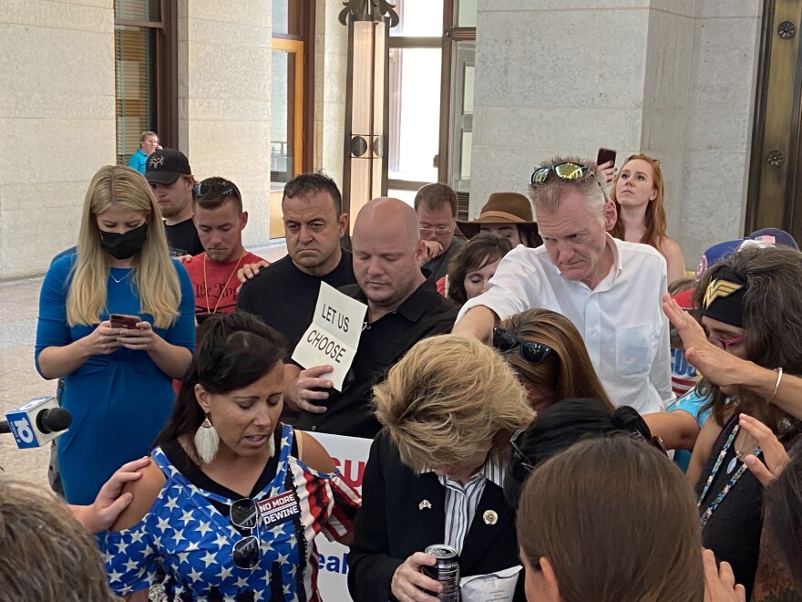 Supporters praying over Rep Jennifer Gross