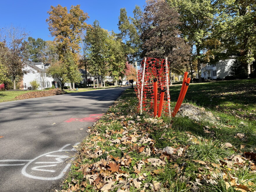 Orange conduits stick out of the ground in a Hudson neighborhood. 