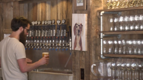 A bartender serves beer at Switchyard Brewing in Bloomington.